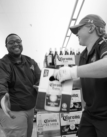 Two Reyes Holdings team members working together and sorting product.