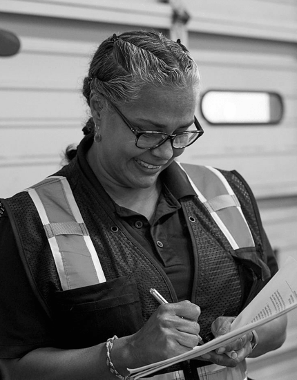 Reyes Holdings team member working at the warehouse and signing some documents.