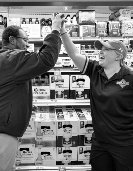 Two Reyes Holdings team members giving each other a high five.