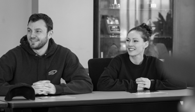 Two Reyes Holdings team members sitting in conference room.